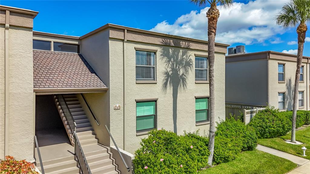 19725 Gulf Boulevard, Unit 46 Indian Rocks Beach, FL 33785 - Photo 42 of 55 a front view of a house with many windows