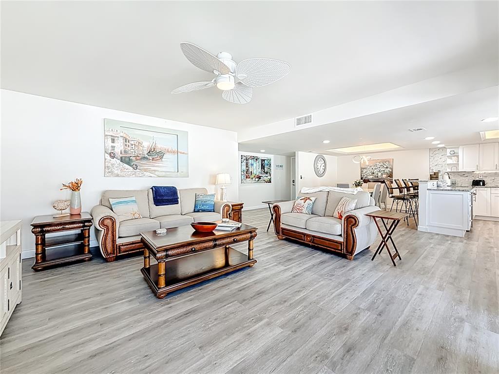 19725 Gulf Boulevard, Unit 46 Indian Rocks Beach, FL 33785 - Photo 6 of 55 a living room with furniture and a wooden floor
