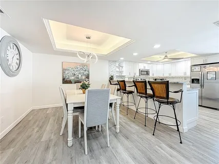 a view of a dining room with furniture and wooden floor
