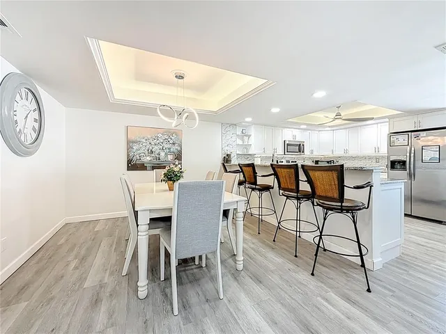 a view of a dining room with furniture and a chandelier