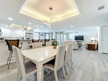 a view of a dining room with furniture and a chandelier