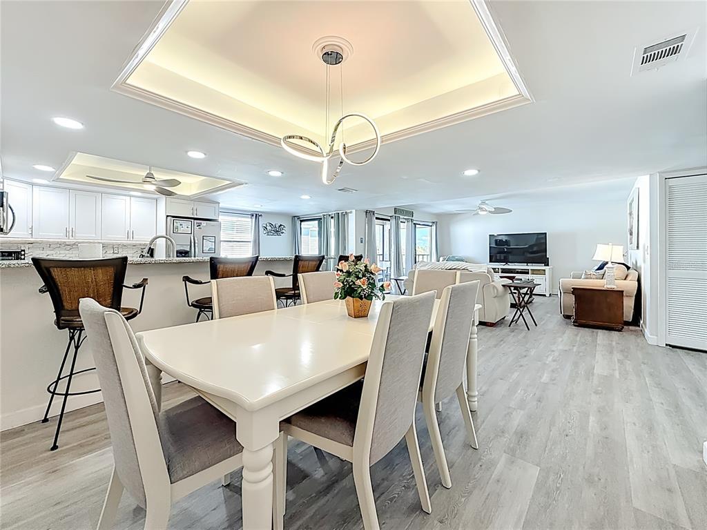 19725 Gulf Boulevard, Unit 46 Indian Rocks Beach, FL 33785 - Photo 10 of 55 a view of a dining room with furniture and a chandelier
