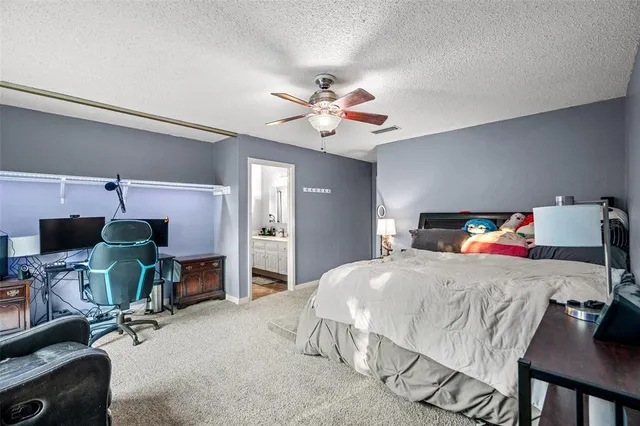 a bedroom with a bed a desk and chair