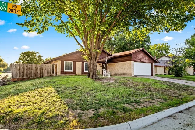a view of a house with yard and a garden