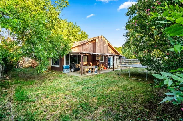 a view of a house with backyard porch and sitting area