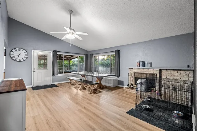 a living room with furniture a fireplace and a table
