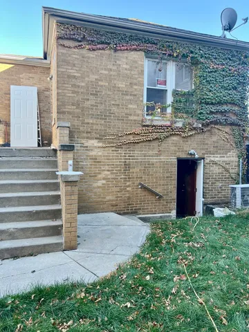a view of a brick house with a large windows