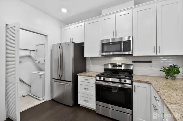 a kitchen with stainless steel appliances a stove a microwave and a refrigerator