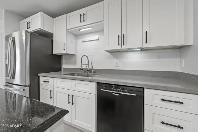 a kitchen with kitchen island granite countertop a sink stove and cabinets