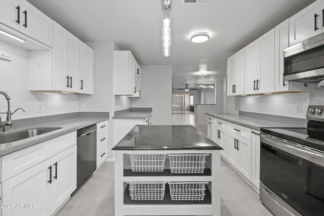 a view of kitchen with stainless steel appliances refrigerator and microwave