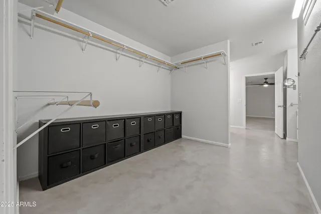 a view of a kitchen with refrigerator and wooden cabinets