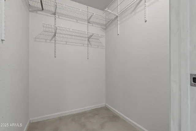 a view of empty room with wooden floor and windows