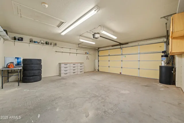 a bedroom with a bed a table and chair