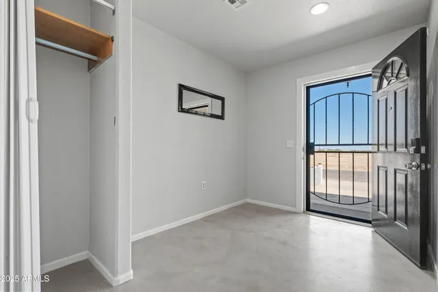 a view of a hallway with wooden floor and windows