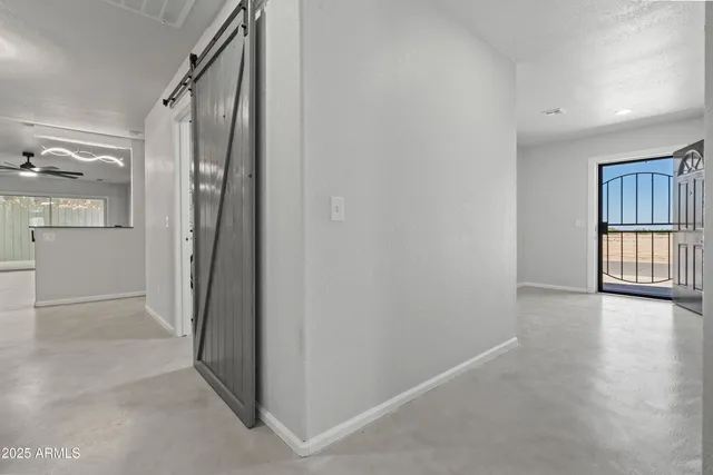 a kitchen with cabinets and chairs