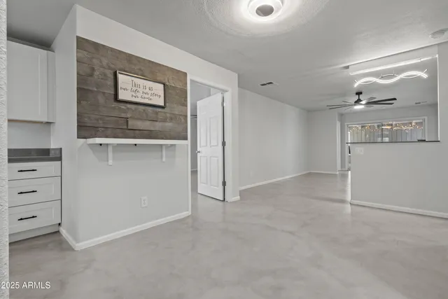a kitchen with white cabinets and appliances