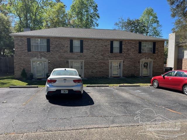 a car parked in front of a brick house