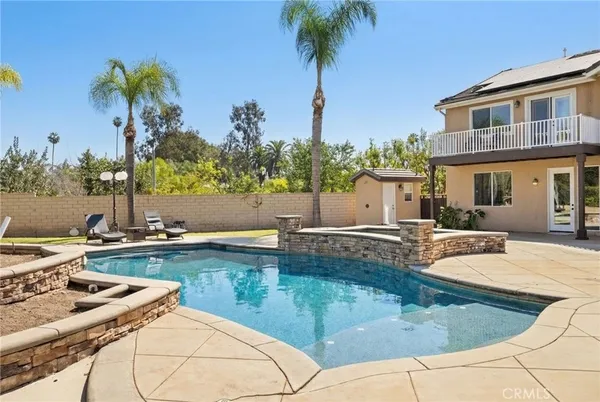 a view of a house with swimming pool and a chair