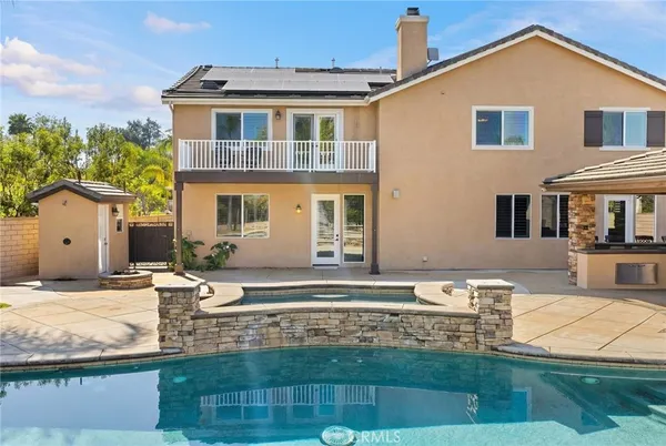 a view of a house with backyard and sitting area