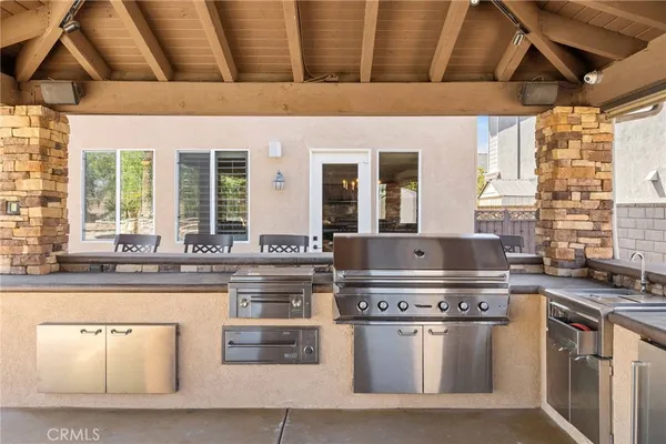 a open kitchen with stainless steel appliances granite countertop a sink a stove and a wooden floors