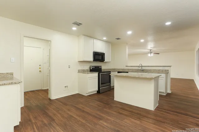 a kitchen with a sink and a stove top oven