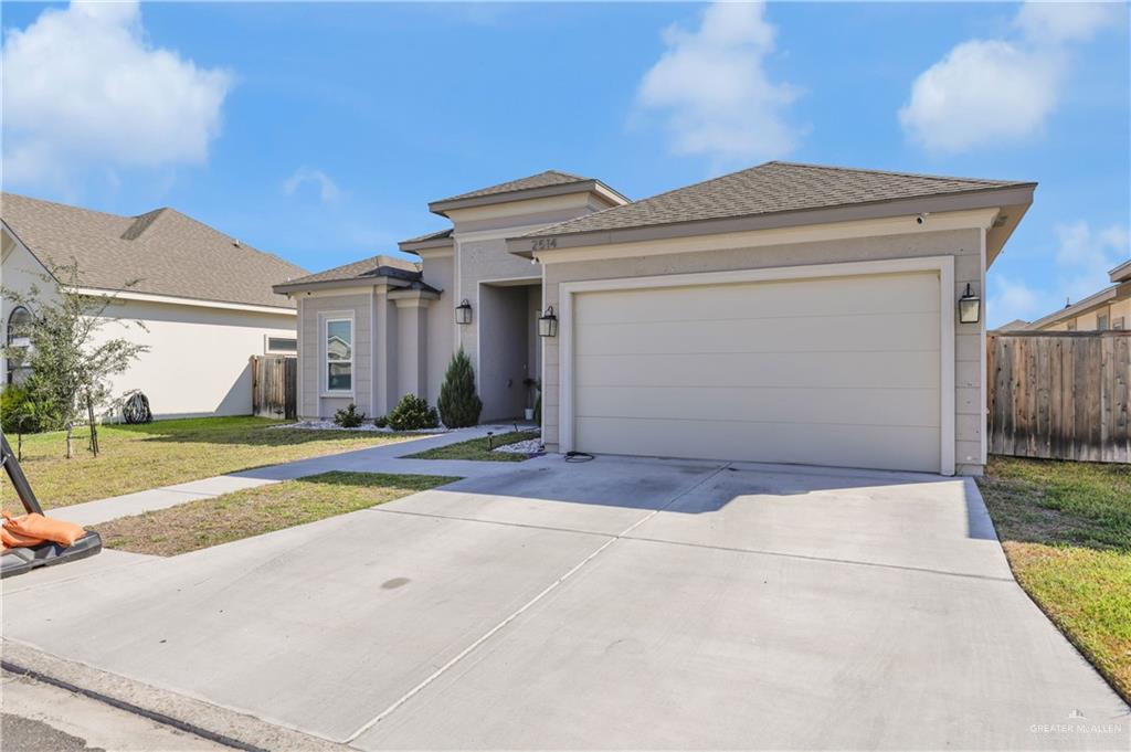 2514 Yarrow Street Mission, TX 78574 - Photo 1 of 22 View of front of home featuring concrete driveway, an attached garage, stucco siding, and roof with shingles
