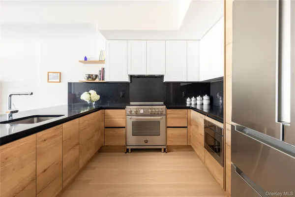 a kitchen with stainless steel appliances granite countertop a stove and a refrigerator