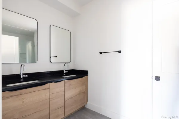 a bathroom with a double vanity sink and a mirror