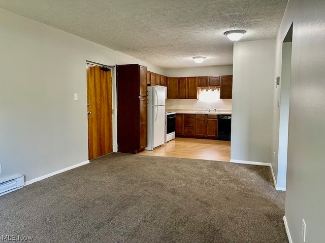 4376 Darrow Road, Unit 7 Stow, OH 44224 - Photo 7 of 23 Kitchen featuring light carpet, a textured ceiling, sink, and white appliances