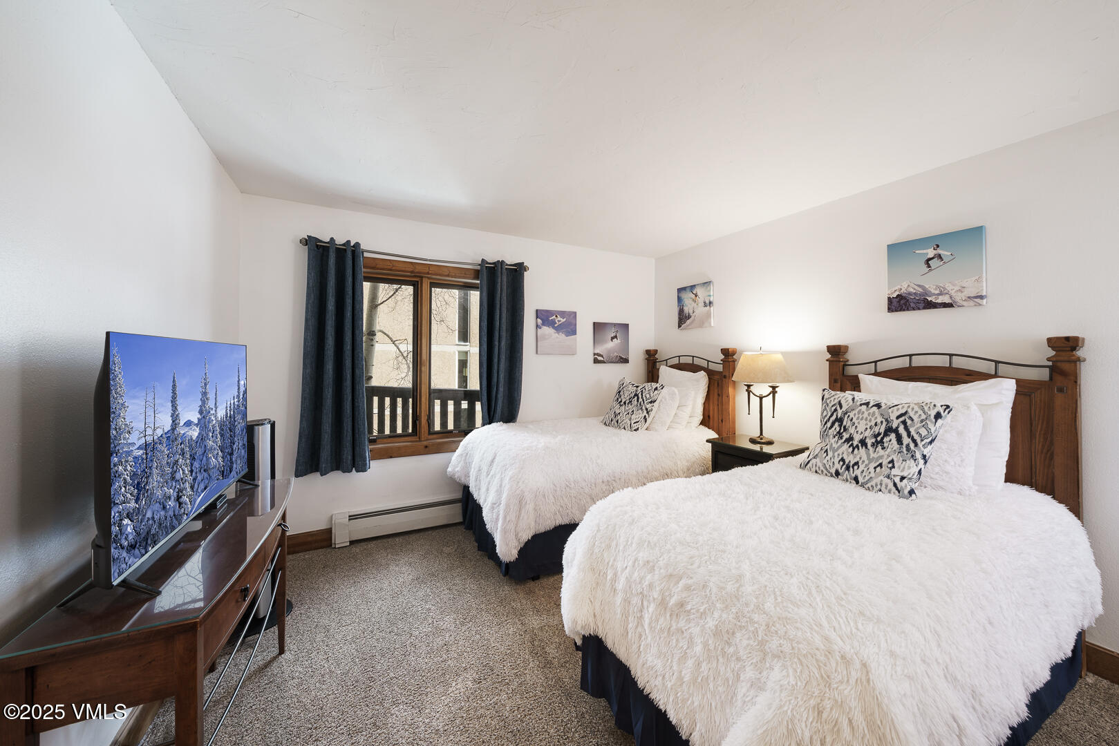 548 South Frontage Road West, Unit 301 Vail, CO 81657 - Photo 11 of 32 a bedroom with two beds and a window