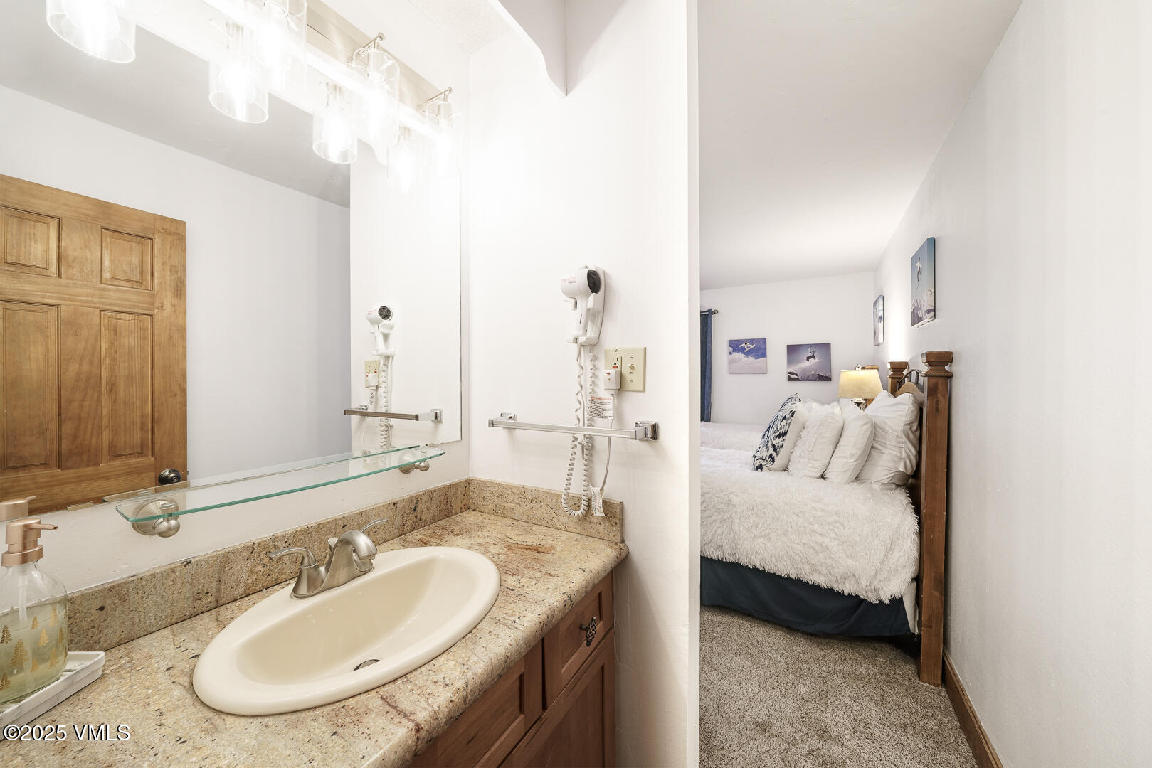 548 South Frontage Road West, Unit 301 Vail, CO 81657 - Photo 13 of 32 a en suite bathroom with a double vanity sink and mirror
