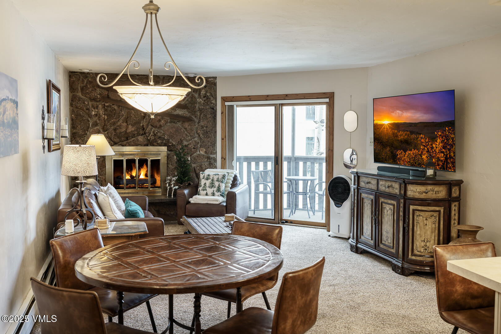 548 South Frontage Road West, Unit 301 Vail, CO 81657 - Photo 18 of 32 a living room with furniture a flat screen tv and a fireplace