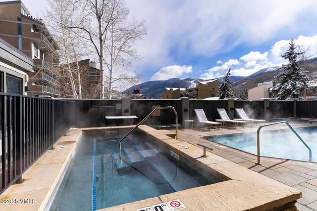 a view of a balcony with two couches and wooden floor