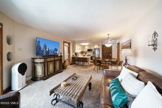 a living room with furniture lamp and window
