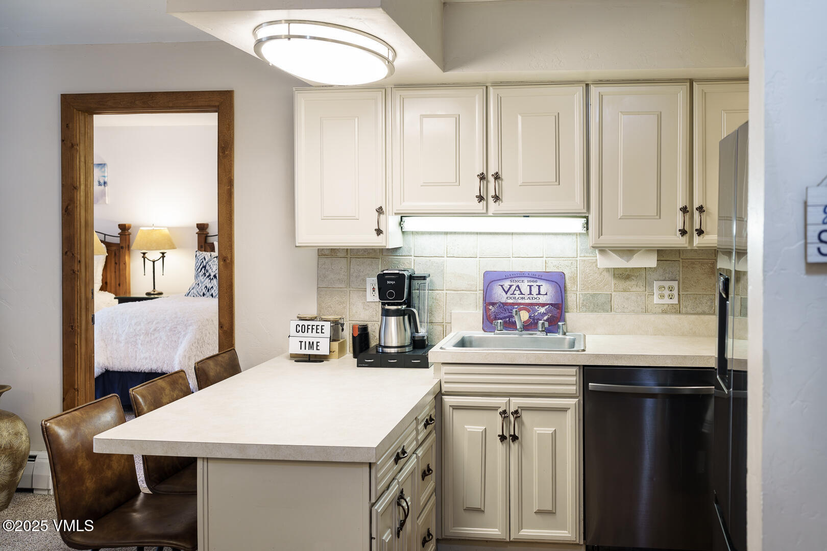 548 South Frontage Road West, Unit 301 Vail, CO 81657 - Photo 10 of 32 a utility room with stainless steel appliances a sink and cabinets