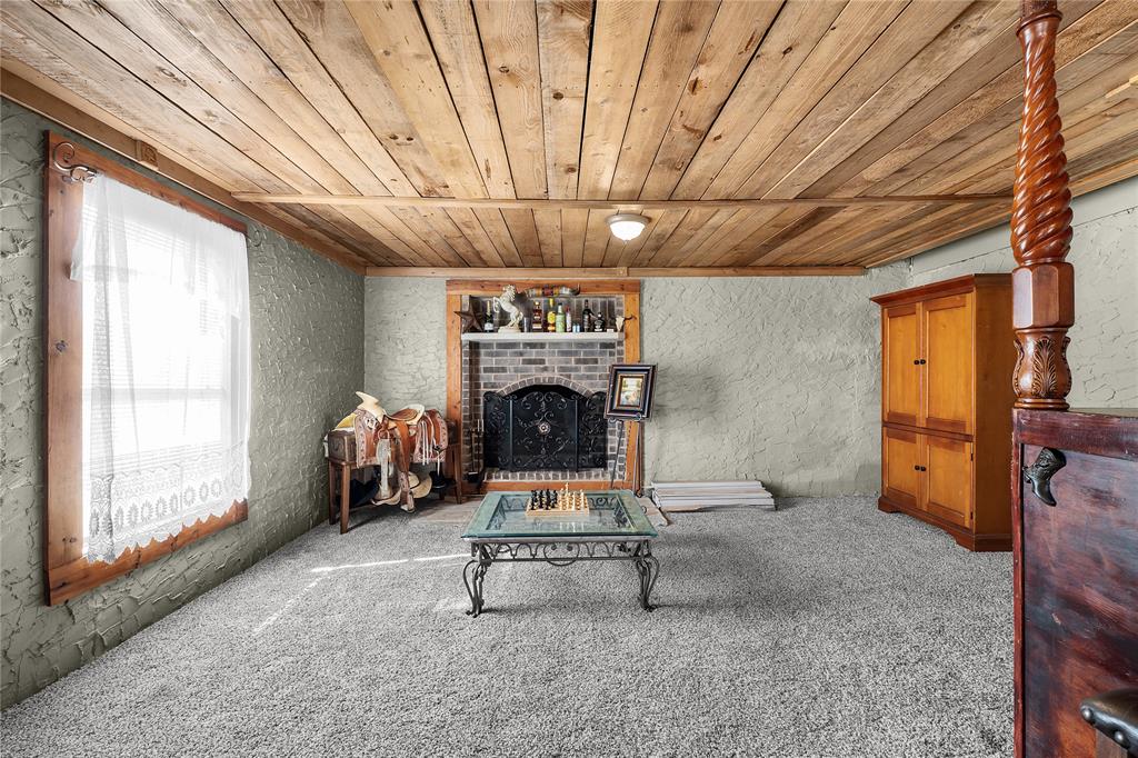 748 Rocky Ridge Lane Weatherford, TX 76085 - Photo 20 of 38 a living room with furniture and a fireplace
