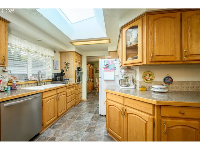 a kitchen with stainless steel appliances granite countertop a sink and cabinets