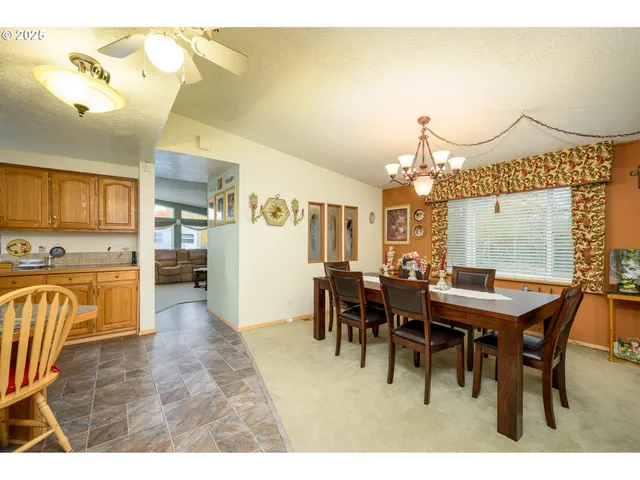 a view of a dining room with furniture and chandelier