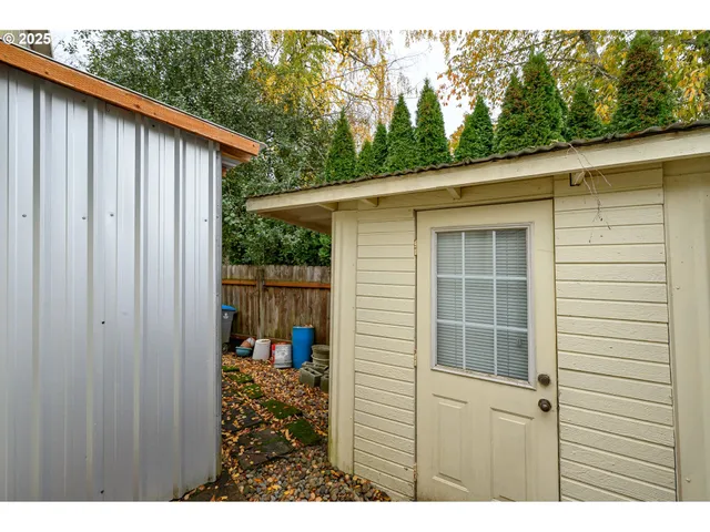 a view of a patio with table and chairs next to a yard