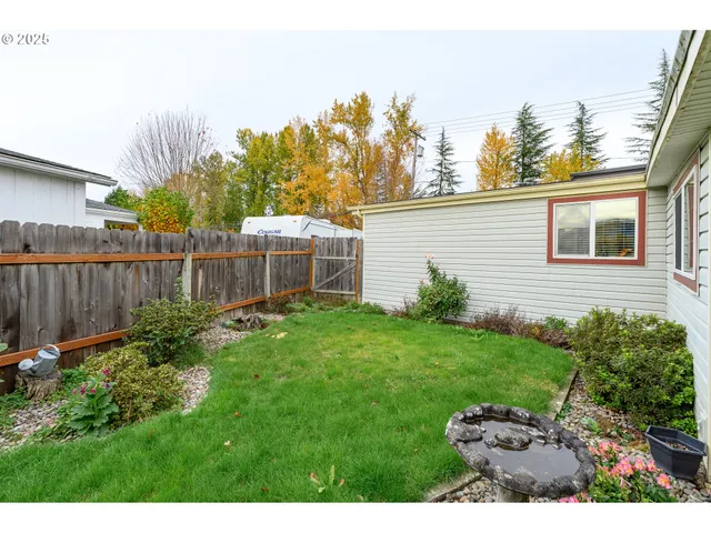 a view of a house with backyard sitting area and garden