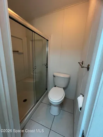 a bathroom with a granite countertop toilet a sink and a shower