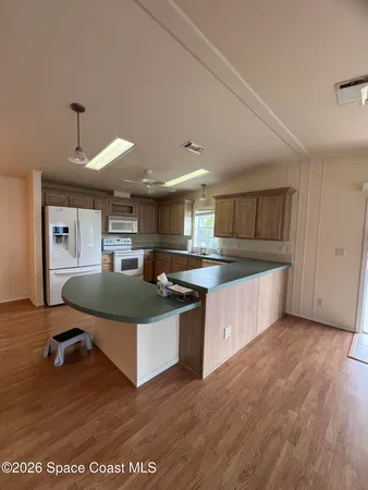 a kitchen with kitchen island a sink and a stove top oven