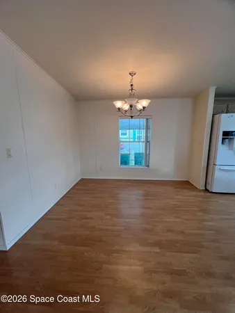 an empty room with a kitchen