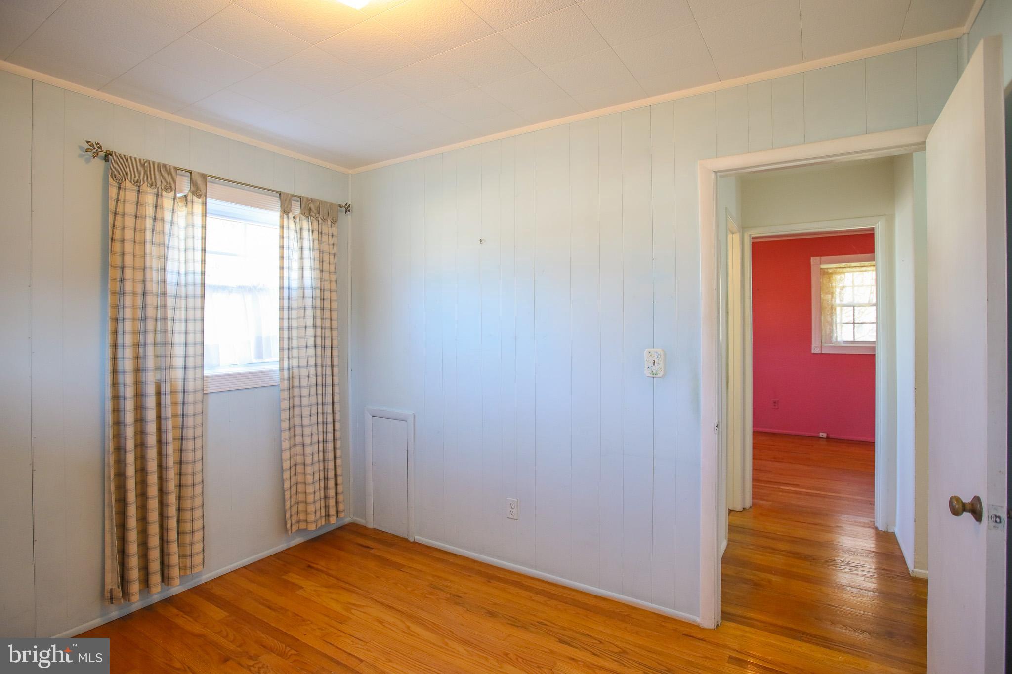 8815 Jandell Road Lorton, VA 22079 - Photo 12 of 27 a view of an empty room with wooden floor and a window