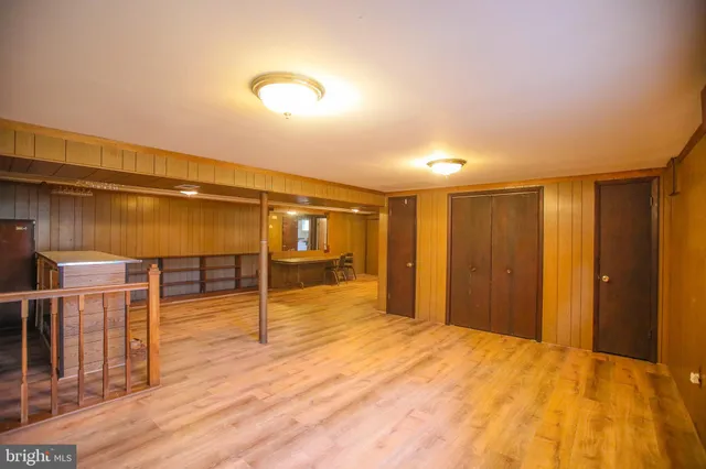 a view of a room with wooden floor