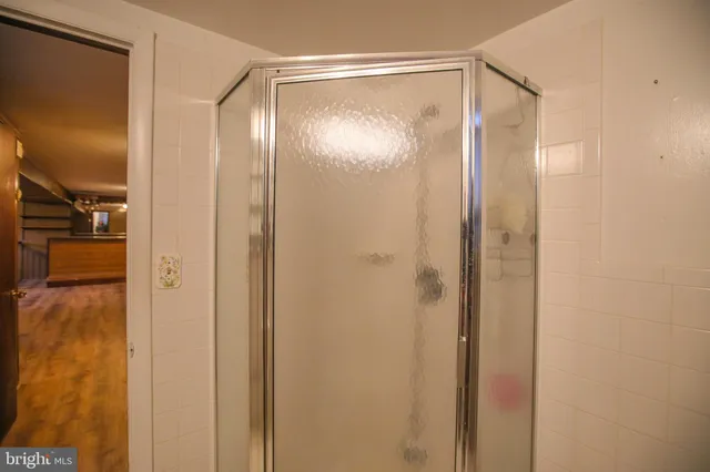 a bathroom with a glass shower door