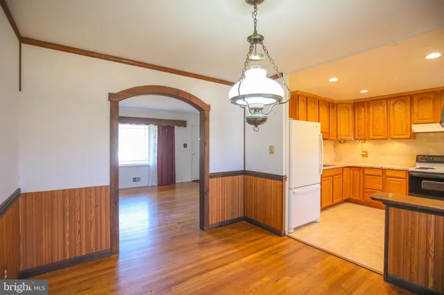 a view of a kitchen with a sink and a refrigerator