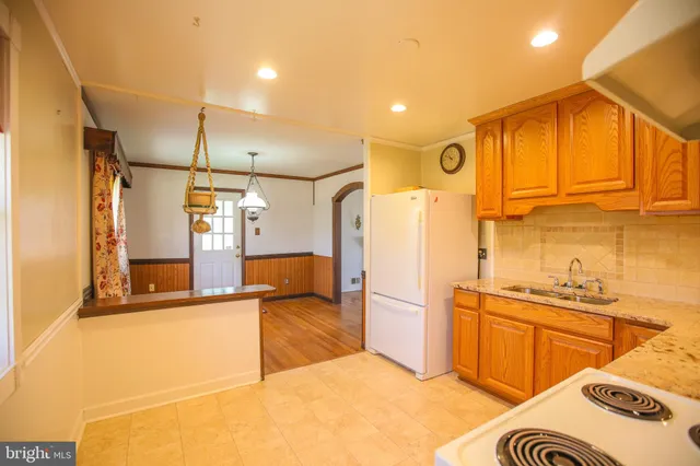 a kitchen with stainless steel appliances granite countertop a sink and cabinets