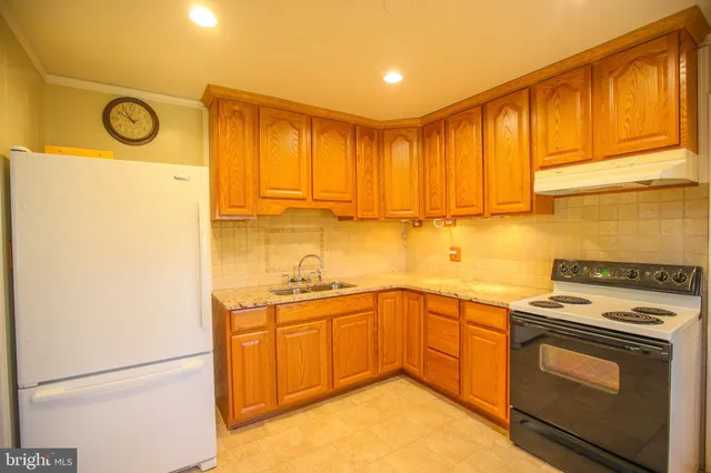 a kitchen with a sink stove and cabinets
