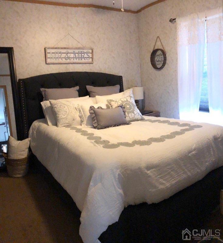 18 3rd Street Avenel, NJ 07001 - Photo 16 of 20 a bedroom with a bed and wooden floor